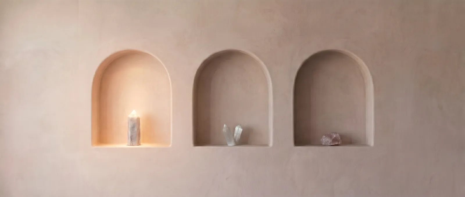 The three plaster niches with the first arch lit by warm light, marking the consultation